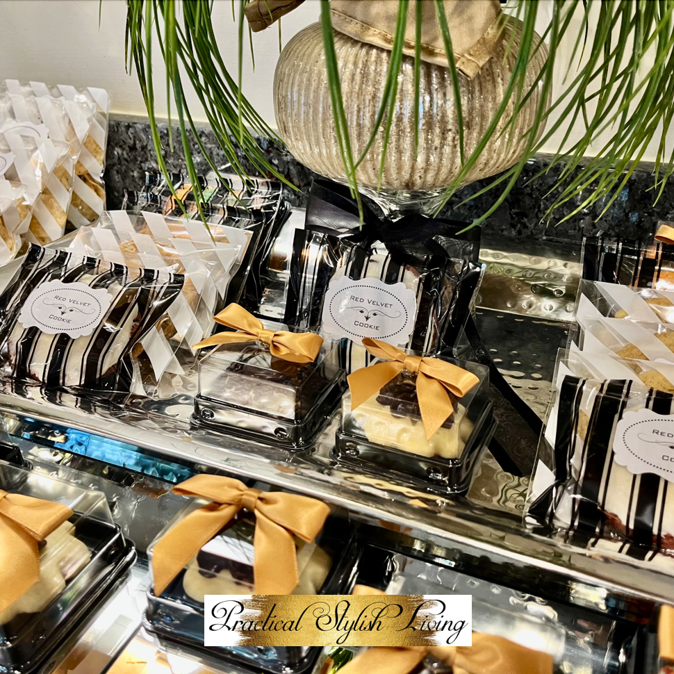 Intimate dinner party desserts elegantly displayed and packaged in the colors of gold, black and white. Safely serving food post Covid.