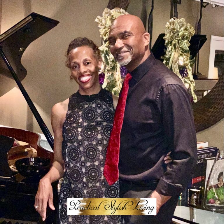 couple standing next to a baby grand piano