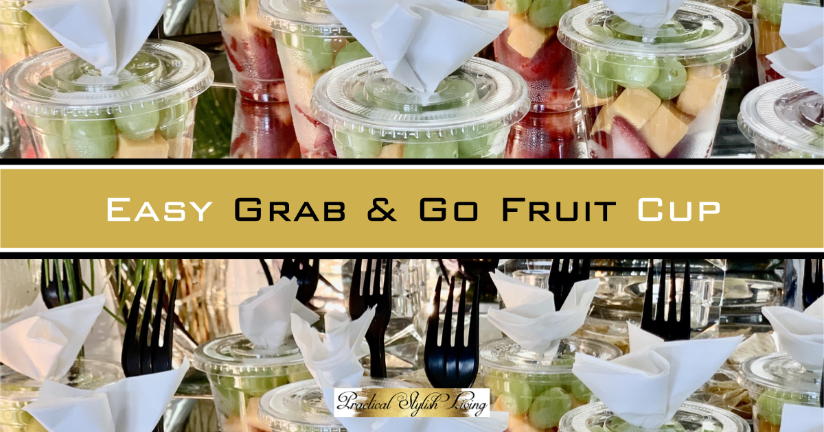 Easy grab and go fruit and cheese cup. Prepackaged grab and go party food. Prepackaged fruit in clear containers that includes strawberries, grapes and cheese with an attached napkin and serving utensil elegantly displayed on a food buffet.