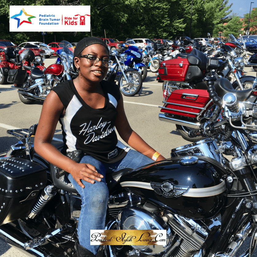 African American girl sitting on Harley Davidson motorcycle