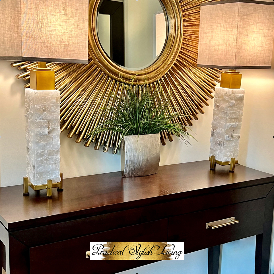 Side table accessorized with buffet lamps and antique silver vase
