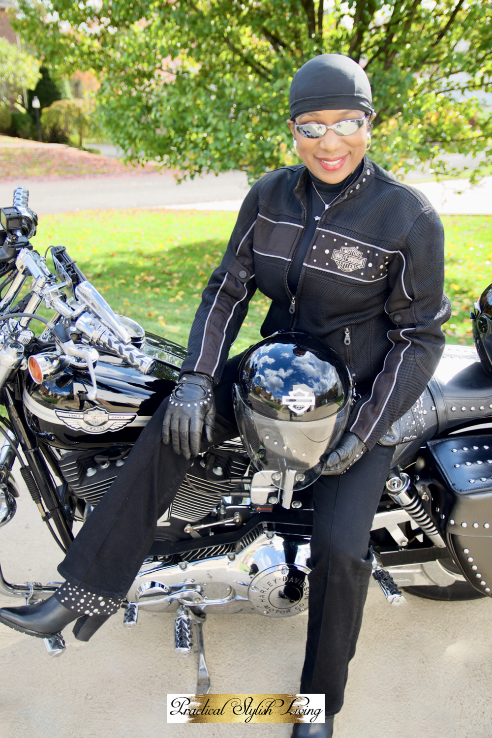 Kimberly R Jones sitting on her Harley-Davidson motorcycle with black riding boots on. Black woman motorcycle rider.